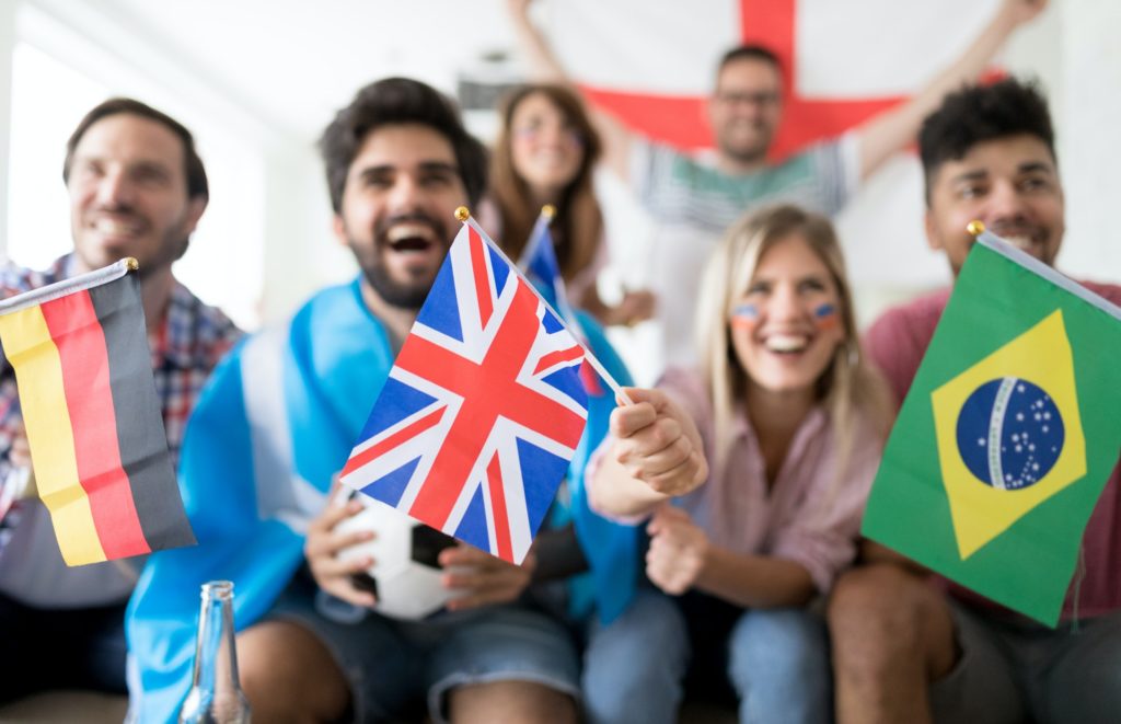 Group of multi-ethnic people celebrating football game