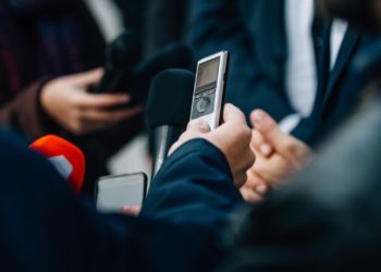 Interviewing businessman on press conference