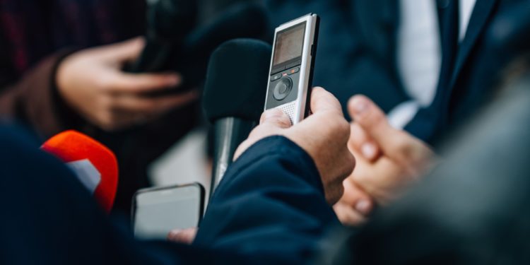 Interviewing businessman on press conference