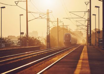 Passenger train at sunrise.