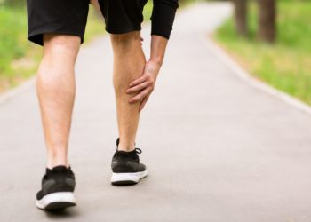 Calf sport muscle injury. Runner with muscle pain in leg