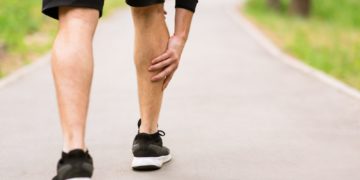Calf sport muscle injury. Runner with muscle pain in leg