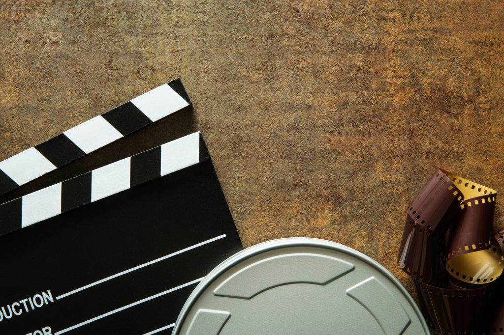 Clapper board with film reel.