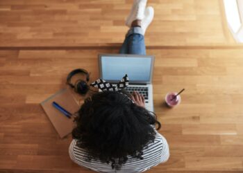 African female university student working online on a campus floor