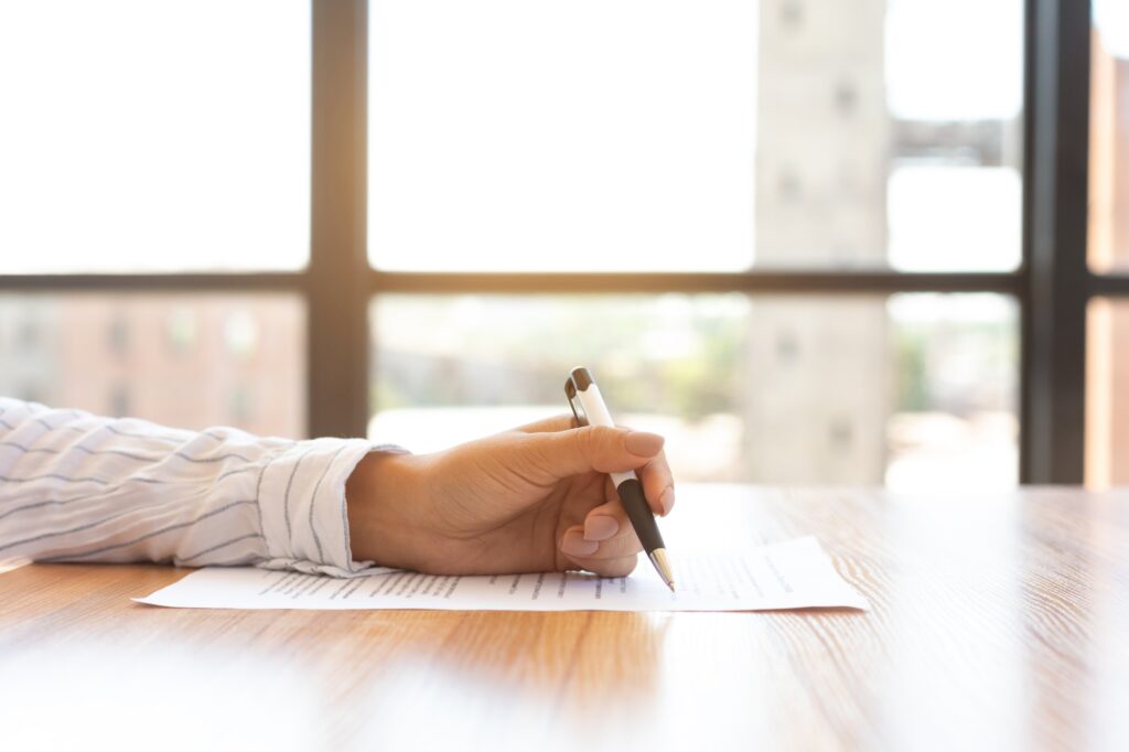 Businesswoman signing a document in modern office