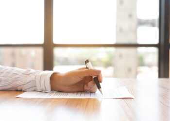 Businesswoman signing a document in modern office