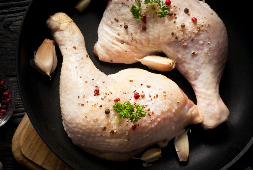 Chicken thighs in a pan.