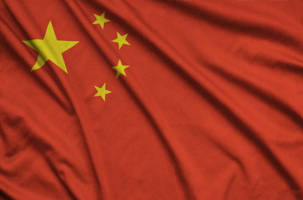 China flag is depicted on a sports cloth fabric with many folds. Sport team waving banner