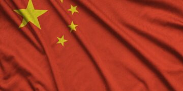 China flag is depicted on a sports cloth fabric with many folds. Sport team waving banner