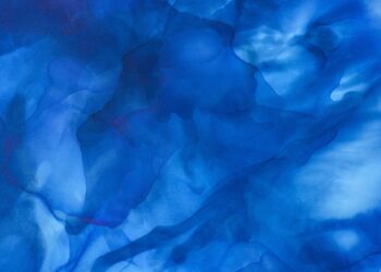 dark blue splashes of alcohol ink as abstract background