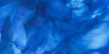 dark blue splashes of alcohol ink as abstract background