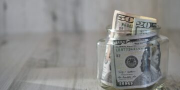 Dollars, money, currency, cash jar hundred dollar bills, salary, extra income, side hustle, earnings