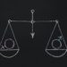 Drawn scales with male and female gender symbols