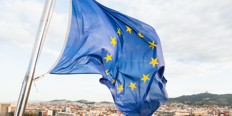 EU flag fluttering by wind above Barcelona