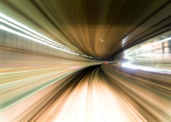 Fast train passing by train station