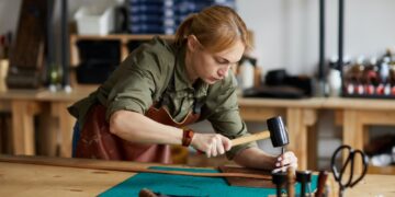 Female Craftsman Working in Shop