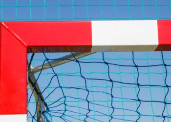 Football or handball goal with red and white goalpost