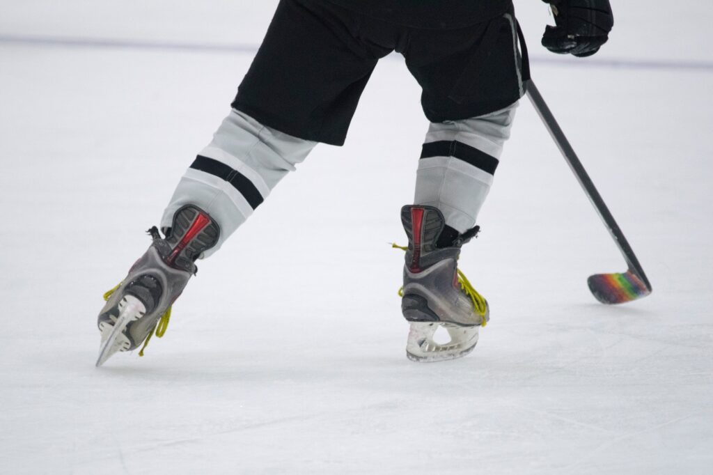 Hitting the Ice for the hockey game - close Up of skates and a hockey stick