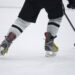 Hitting the Ice for the hockey game - close Up of skates and a hockey stick