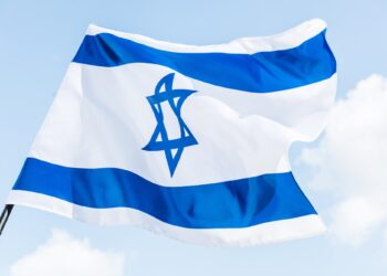 low angle view of national israel flag with star of david against blue sky