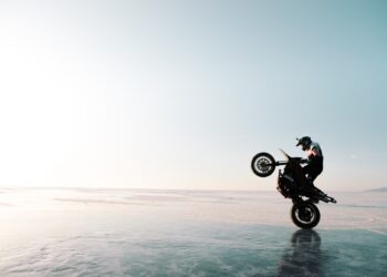 motorbiker riding on one wheel
