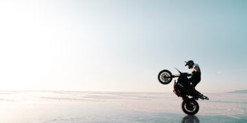 motorbiker riding on one wheel