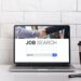 Pc on the desk with job search engine on display