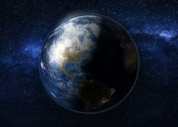 Planet Earth in black and blue Universe of stars