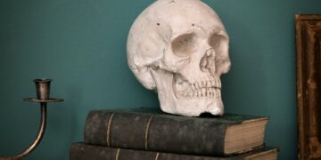 Replica of a human skull on vintage books