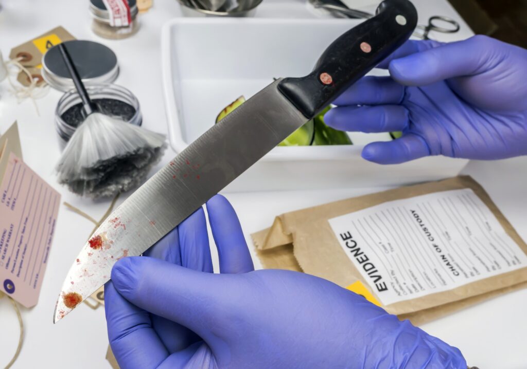 Scientist takes samples of a knife in laboratory, conceptual image