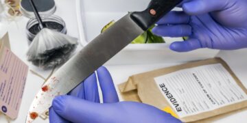 Scientist takes samples of a knife in laboratory, conceptual image