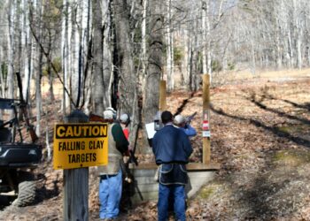 Shooting sporting clay pigeons at a shooting range with shotguns