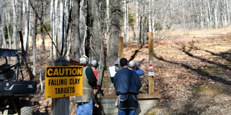 Shooting sporting clay pigeons at a shooting range with shotguns