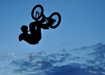 Silhouette of a BMX bycicle rider in the air