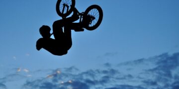 Silhouette of a BMX bycicle rider in the air