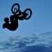 Silhouette of a BMX bycicle rider in the air