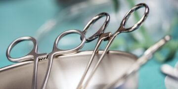 Some scissors for surgery on a tray, conceptual image