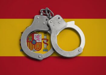 Spain flag and police handcuffs