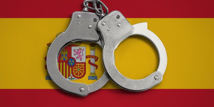 Spain flag and police handcuffs