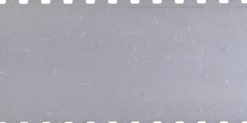 Strip of old celluloid film with dust and scratches
