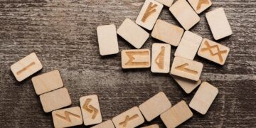Top View of Runes With Symbols on Wooden Background