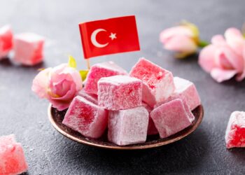Turkish Delight, Rose Flavour in a Copper Plate with Turkish Flag. Grey Background. Close up.