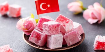 Turkish Delight, Rose Flavour in a Copper Plate with Turkish Flag. Grey Background. Close up.
