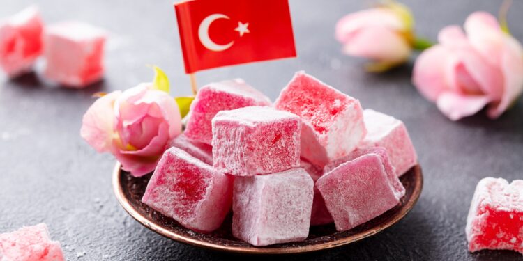 Turkish Delight, Rose Flavour in a Copper Plate with Turkish Flag. Grey Background. Close up.