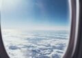 view of blue cloudy sky from airplane window