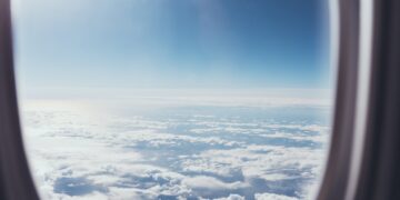 view of blue cloudy sky from airplane window