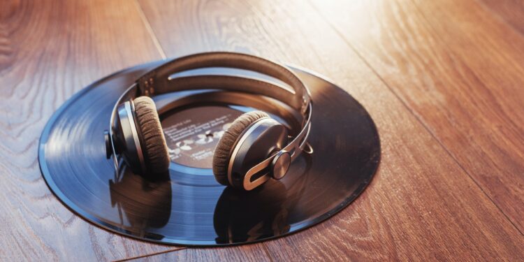 vinyl record and headphone over wooden table. Audio enthusiast,music lover or professional disc