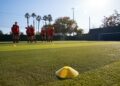 Womens Football Team Training For Soccer Match On Outdoor Astro Turf Pitch