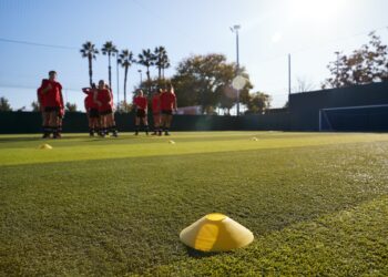 Womens Football Team Training For Soccer Match On Outdoor Astro Turf Pitch